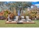 Backyard wooden deck with lounge chairs and an umbrella surrounded by lush landscaping at 2029 Country Manor Dr, Mount Pleasant, SC 29466