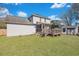 Home exterior shot of deck with steps down to a spacious, green backyard and lawn shed at 2029 Country Manor Dr, Mount Pleasant, SC 29466