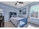 Coastal themed bedroom with blue walls, blue bed frame and ceiling fan at 2029 Country Manor Dr, Mount Pleasant, SC 29466