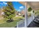 Inviting front porch view with rocking chairs, lush lawn, and a mature tree on a sunny day at 2029 Country Manor Dr, Mount Pleasant, SC 29466