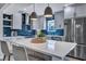 Modern kitchen features a large island, stainless steel appliances, and elegant blue backsplash, perfect for cooking at 2029 Country Manor Dr, Mount Pleasant, SC 29466