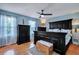 This main bedroom boasts a dark wood bedroom set, ceiling fan, and light blue walls at 2029 Country Manor Dr, Mount Pleasant, SC 29466