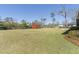 Large backyard with a shed, offering ample space and storage, set against a clear blue sky at 209 Brailsford Rd, Summerville, SC 29485