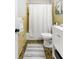 Full bathroom featuring white cabinets, a toilet, patterned floor, and tiled walls at 209 Brailsford Rd, Summerville, SC 29485