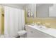 Bright bathroom with a white vanity, yellow tile, and shower with a white curtain at 209 Brailsford Rd, Summerville, SC 29485