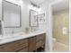 Double sink bathroom with tile flooring and two mirrors at 209 Brailsford Rd, Summerville, SC 29485