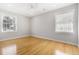 Neutral bedroom with hardwood floors and two large windows allowing lots of light at 209 Brailsford Rd, Summerville, SC 29485