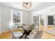 Bright dining room with a glass table set on a hardwood floor, next to a window at 209 Brailsford Rd, Summerville, SC 29485