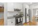 Modern kitchen features stainless steel appliances, white cabinets, and granite countertops at 209 Brailsford Rd, Summerville, SC 29485