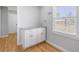 Bright laundry room features white cabinets with granite countertops and a window that lets in light at 209 Brailsford Rd, Summerville, SC 29485