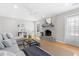 Spacious living room with a gray brick fireplace, ceiling fan, and hardwood floors at 209 Brailsford Rd, Summerville, SC 29485