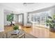 Bright, airy living room featuring hardwood floors, large windows, and a seamless transition to the dining area at 209 Brailsford Rd, Summerville, SC 29485