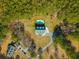 Overhead view showcases a beautifully designed home with a pool, nestled amidst a dense forest at 214 Shelby Shea Ln, Moncks Corner, SC 29461