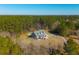 Gorgeous property featuring a private pool surrounded by dense green trees and a winding driveway at 214 Shelby Shea Ln, Moncks Corner, SC 29461