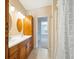 Bathroom features a double vanity, wood cabinets, and shower with decorative curtain at 214 Shelby Shea Ln, Moncks Corner, SC 29461