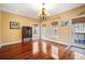Elegant dining room with hardwood floors and a chandelier, creating a perfect ambiance for formal dinners at 214 Shelby Shea Ln, Moncks Corner, SC 29461