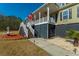 Inviting entrance with elegant stairway and a cozy porch, adorned with American and Marine Corps flags at 214 Shelby Shea Ln, Moncks Corner, SC 29461