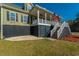 Inviting entrance with elegant stairway and a cozy porch, adorned with American and Marine Corps flags at 214 Shelby Shea Ln, Moncks Corner, SC 29461