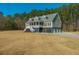 Two-story home with a welcoming front porch, an inviting entrance, and attached garages at 214 Shelby Shea Ln, Moncks Corner, SC 29461