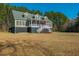 Two-story home with a welcoming front porch, an inviting entrance, and a large manicured front yard at 214 Shelby Shea Ln, Moncks Corner, SC 29461