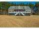 Charming two-story home with welcoming front porch and a manicured front yard, perfect for curb appeal at 214 Shelby Shea Ln, Moncks Corner, SC 29461