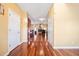 Inviting hallway with hardwood floors and a view of the living room featuring a fireplace at 214 Shelby Shea Ln, Moncks Corner, SC 29461