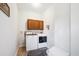 Bright laundry room featuring a washer and dryer set, storage cabinets, and a decorative rug on tile flooring at 214 Shelby Shea Ln, Moncks Corner, SC 29461