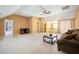 Spacious living room features neutral carpet, a ceiling fan, and access to upstairs at 214 Shelby Shea Ln, Moncks Corner, SC 29461