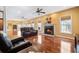 Open-concept living area with hardwood floors, a fireplace, and large windows for natural light at 214 Shelby Shea Ln, Moncks Corner, SC 29461