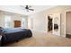 Comfortable bedroom with a ceiling fan, two large windows, and an open closet with ample storage solutions at 214 Shelby Shea Ln, Moncks Corner, SC 29461