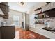 Well-lit mud room offering built-in shelving, a spacious storage cabinet, and durable wood flooring at 214 Shelby Shea Ln, Moncks Corner, SC 29461