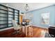 Bright office featuring built-in shelves, hardwood floors, and a modern desk setup with dual monitors at 214 Shelby Shea Ln, Moncks Corner, SC 29461
