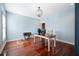 Well-lit office space with blue walls, hardwood floors, and a modern desk setup with computer and chair at 214 Shelby Shea Ln, Moncks Corner, SC 29461