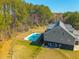Scenic backyard with a refreshing pool and meticulously maintained lawn, perfect for outdoor relaxation and entertainment at 214 Shelby Shea Ln, Moncks Corner, SC 29461