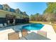 Backyard view features an in-ground pool and house with dual level porch at 214 Shelby Shea Ln, Moncks Corner, SC 29461
