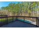 Backyard pool deck featuring wooden flooring and overlooks swimming pool surrounded by forest trees in a bright scenery at 214 Shelby Shea Ln, Moncks Corner, SC 29461