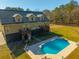 Inviting backyard featuring a sparkling pool, surrounded by ample seating and a well-maintained fenced yard at 214 Shelby Shea Ln, Moncks Corner, SC 29461