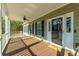 Inviting front porch featuring a ceiling fan, providing a comfortable and stylish outdoor space at 214 Shelby Shea Ln, Moncks Corner, SC 29461