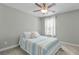 Calm bedroom with a blue and white striped bedspread, ceiling fan, and neutral walls at 2333 Town Woods Rd, Charleston, SC 29414