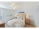 Bright bedroom featuring a ceiling fan, two bedside tables, and coastal decor at 236 Driftwood Ln, Edisto Island, SC 29438