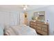 This charming bedroom features a beachy aesthetic, a ceiling fan, and ample storage within the closet at 236 Driftwood Ln, Edisto Island, SC 29438