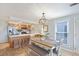 Cozy dining room adjacent to kitchen features seating for six under an elegant chandelier at 236 Driftwood Ln, Edisto Island, SC 29438