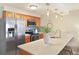 Bright kitchen with stainless appliances, breakfast bar, and decorative tile backsplash at 236 Driftwood Ln, Edisto Island, SC 29438