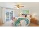 Bright main bedroom with ceiling fan, balcony access, and decorative beach accents at 236 Driftwood Ln, Edisto Island, SC 29438
