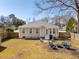 Back view of a home, featuring a spacious yard, seating area, and mature trees providing shade at 2634 Lani Ct, Charleston, SC 29414