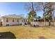 Expansive backyard with a well-manicured lawn, patio seating, and a view of the home's exterior at 2634 Lani Ct, Charleston, SC 29414