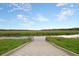 Picturesque marsh view with a wooden walkway leading to the serene water, under a partly cloudy sky at 2774 Hidden Oak Dr, Seabrook Island, SC 29455