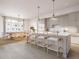 Bright, open kitchen featuring a large island with seating, modern lighting, and stainless steel appliances at 317 Longshore St # 317, Charleston, SC 29492
