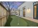 Backyard putting green with lush landscaping and charming home at 34 Percy St, Charleston, SC 29403
