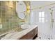 Modern bathroom featuring stylish green tile, marble countertop, and a glass-enclosed shower at 34 Percy St, Charleston, SC 29403
